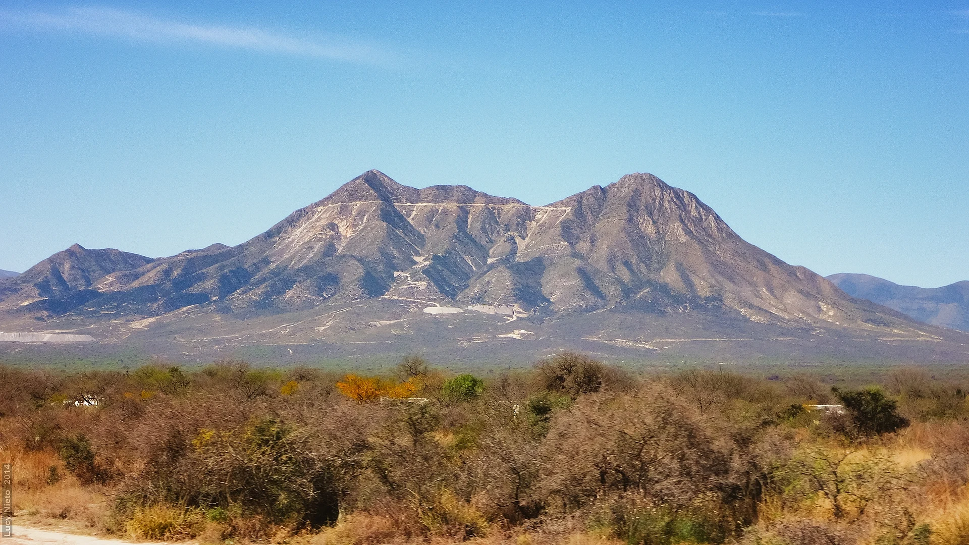 Cerro del Fraile, the mountain above Villa de la Paz, with mining roads cut across its slopes, seen over desert scrub, San Luis Potosí