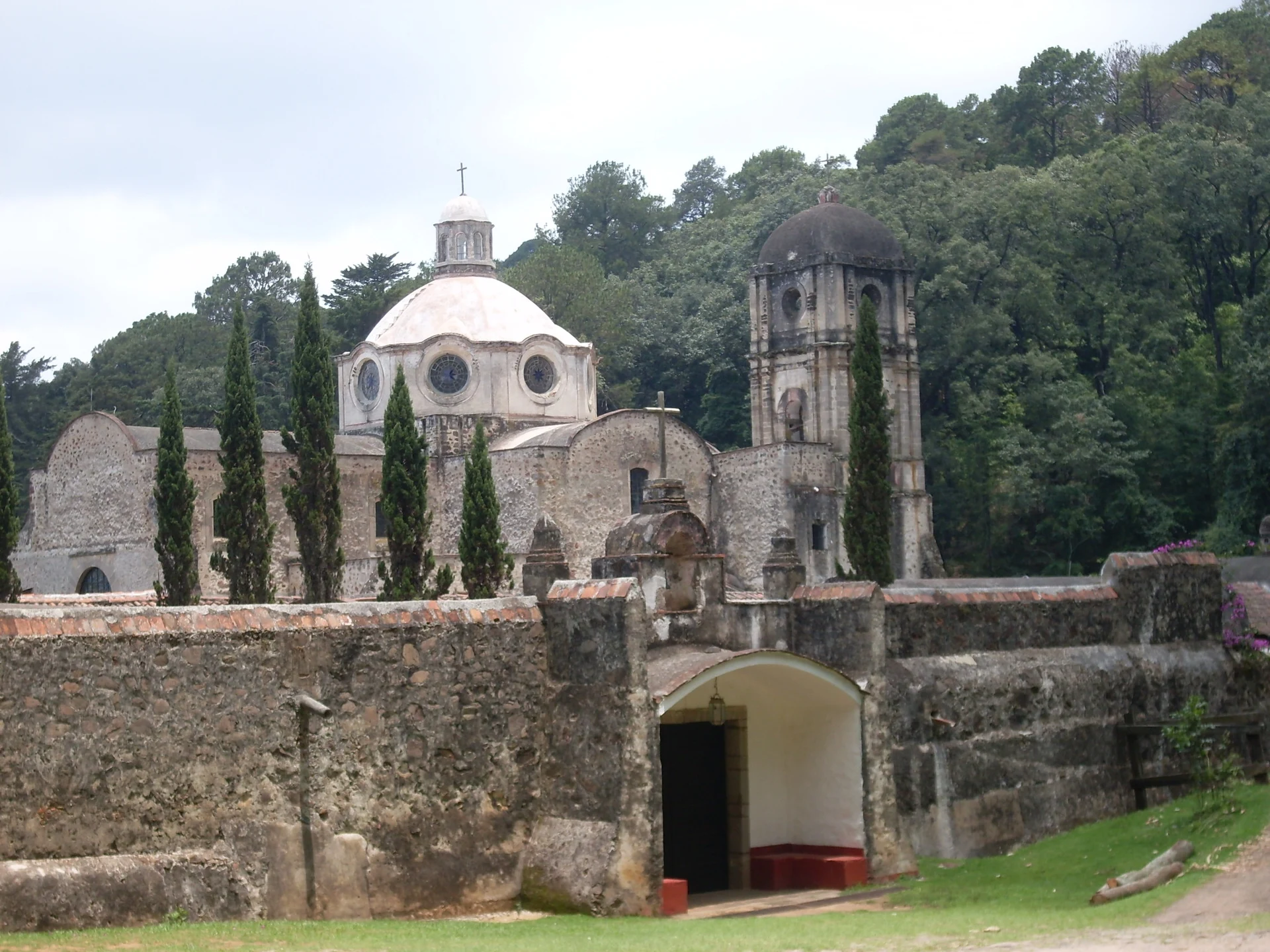 Stone walls and domed church of the Santo Desierto del Carmen among cypresses, Estado de México