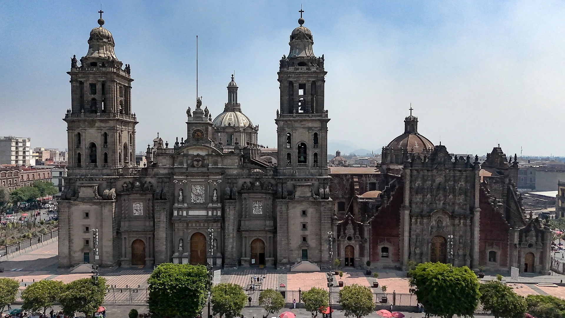 Front of Mexico City's Metropolitan Cathedral with its two bell towers and dome, and the carved façade of the Sagrario Metropolitano to the right, Catedral Metropolitana