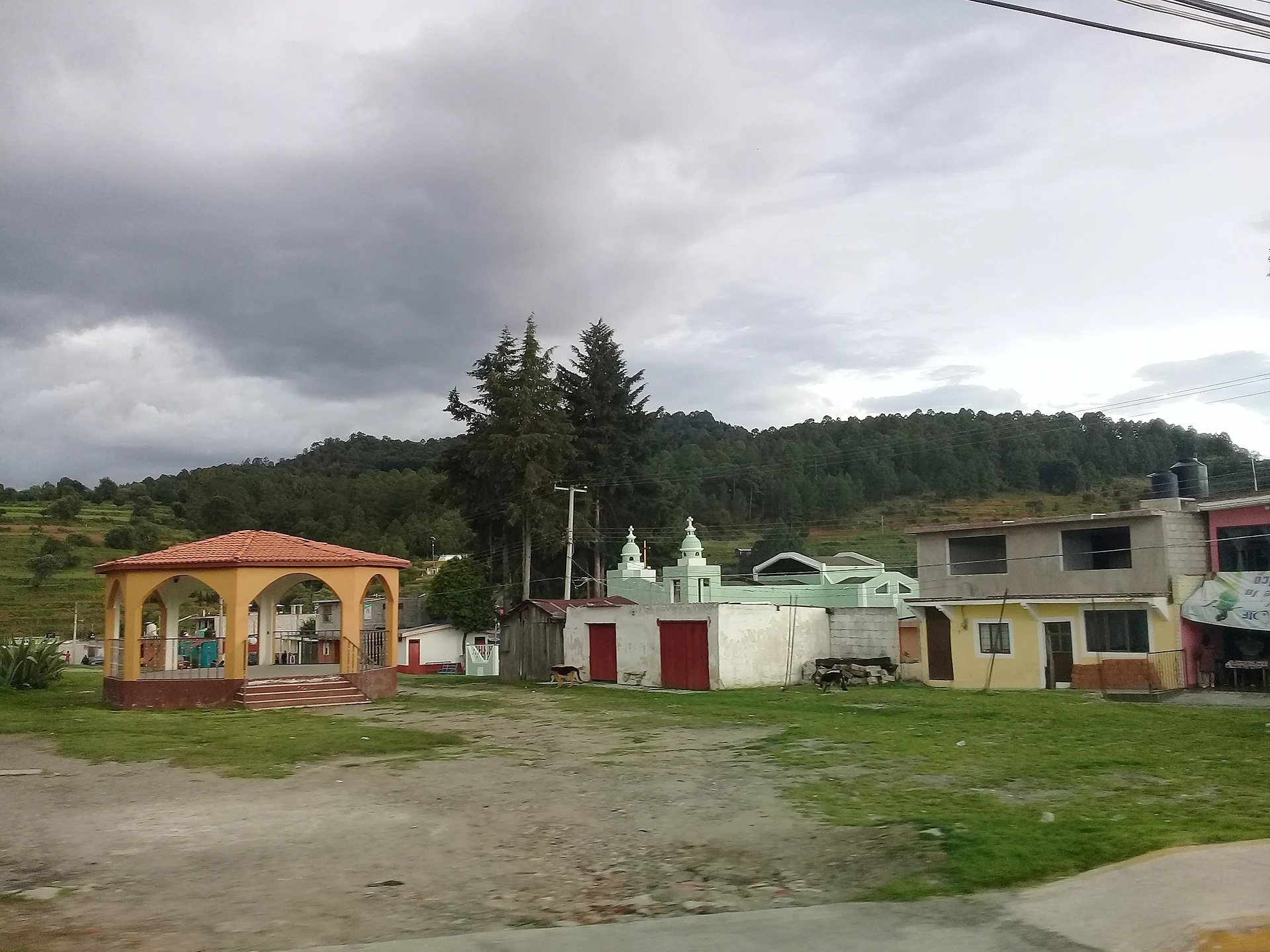 Village green and kiosk of San Felipe Hidalgo with pine forest behind, Tlaxcala