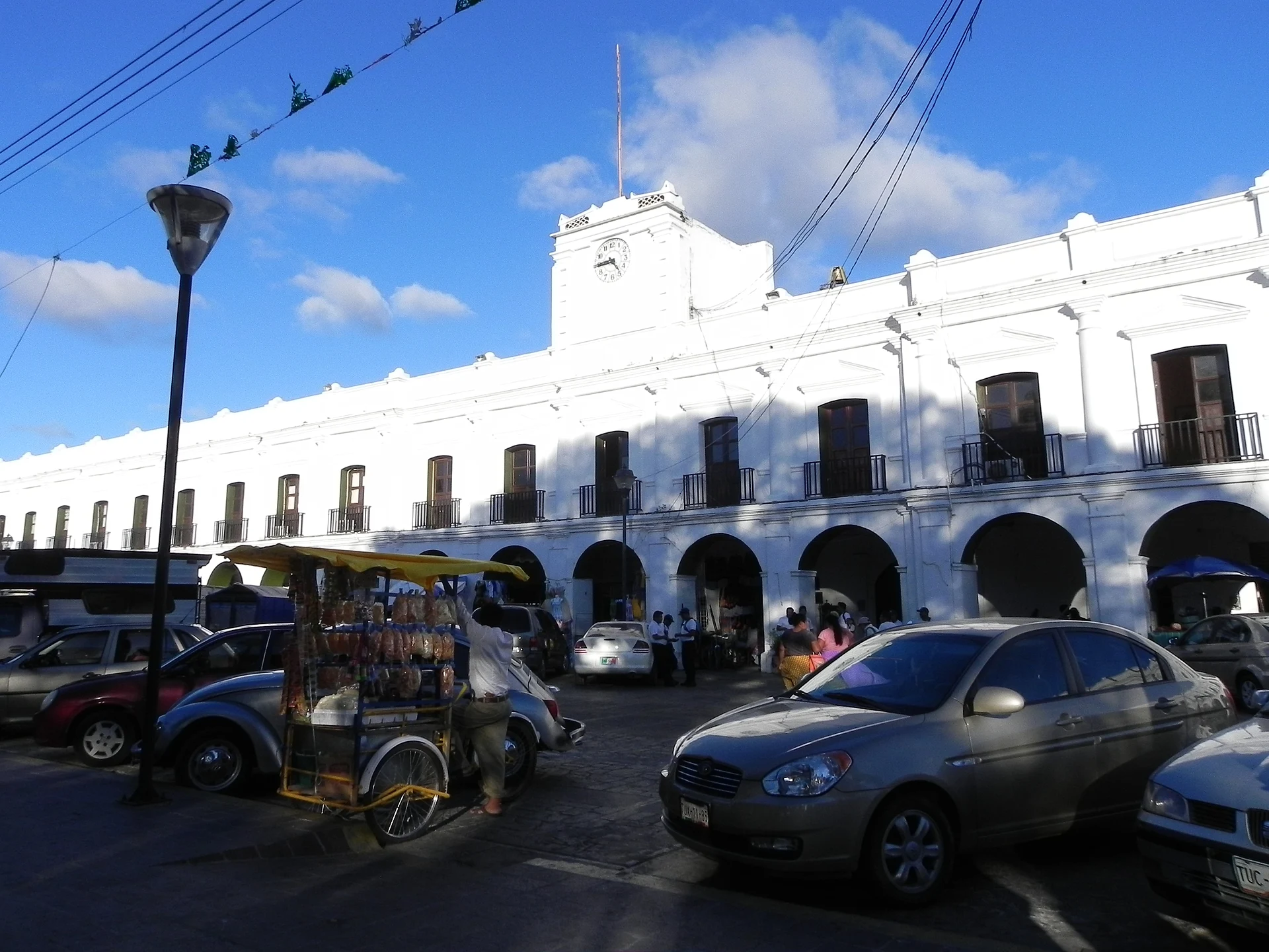 The long arcaded front of Juchitán's municipal palace on the main square, under a blue sky, Juchitán de Zaragoza, Oaxaca