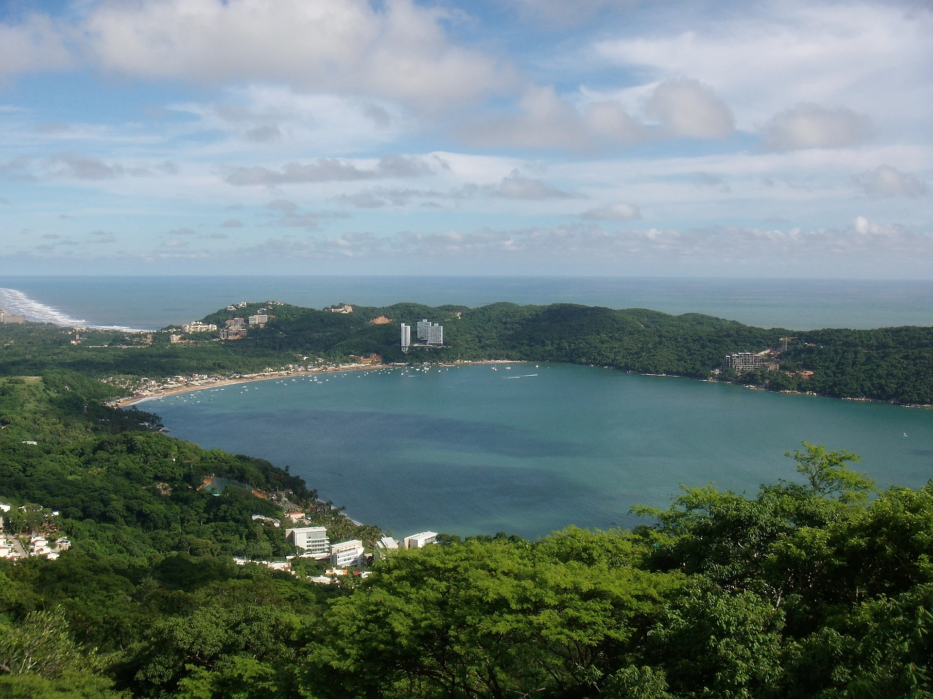 The round bay of Puerto Marqués seen from the hills above, with its beach and the Pacific beyond, Guerrero